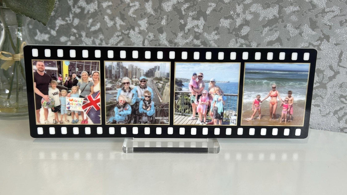 Film strip photo display with family photos against a textured wall.