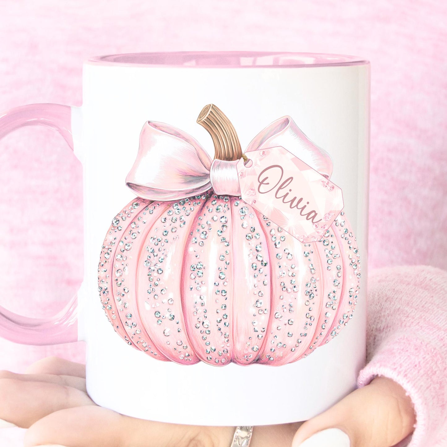 Pink pumpkin-shaped mug with a bow and 'Olivia' text on a pink background